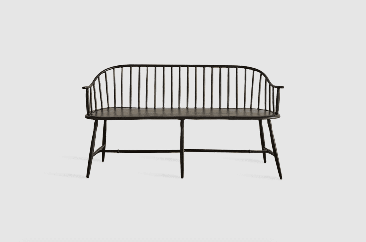 A black, slatted bench with a curved back and armrests. The bench features turned legs connected by… — 3D model