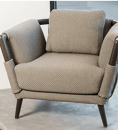 A contemporary armchair with a fabric-covered frame, featuring a textured weave. It has a prominent… — 3D model