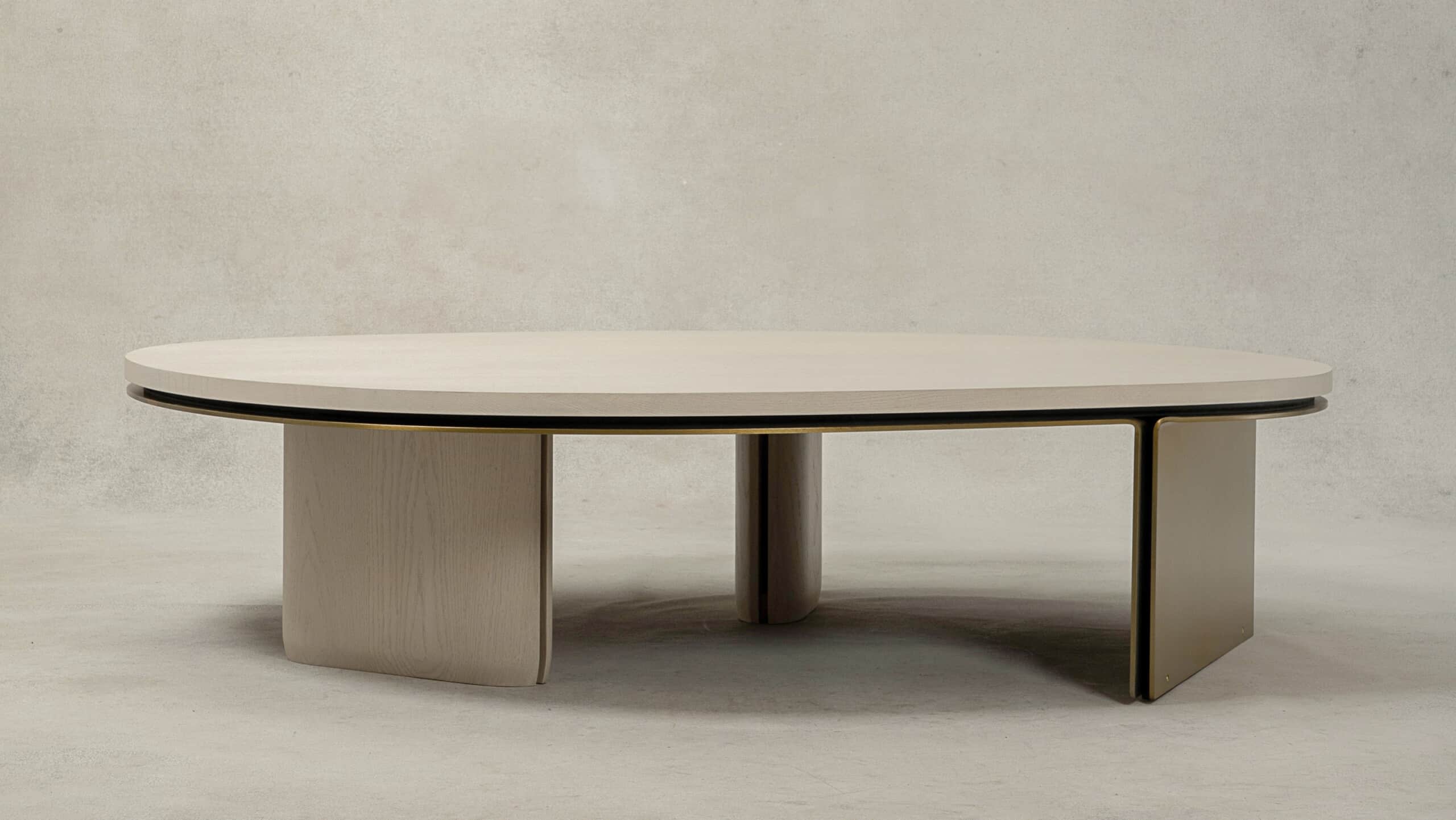 An oval coffee table featuring a light-toned wood veneer top with a thin dark edge and an integrated… — 3D model