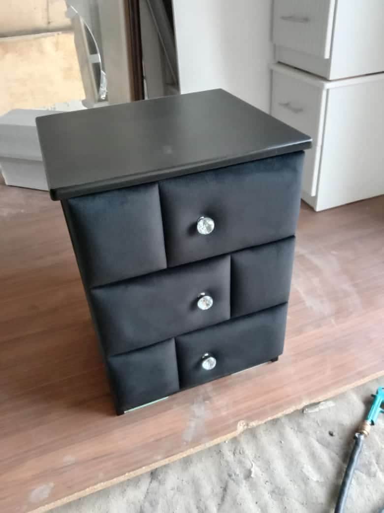 A sleek, black three-drawer storage unit, likely serving as a nightstand or small chest. It features… — 3D model