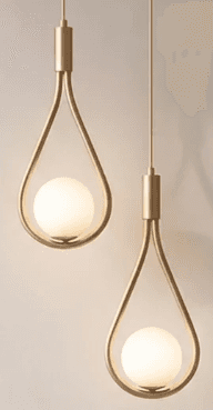 A modern pendant light featuring a teardrop-shaped brass frame enclosing a spherical opal glass diff… — 3D model
