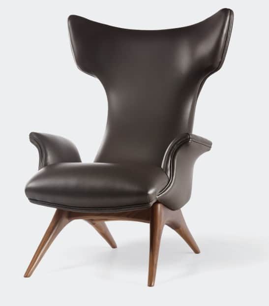 A contemporary wingback lounge chair featuring dark brown leather upholstery and a sculpted wooden b… — 3D model
