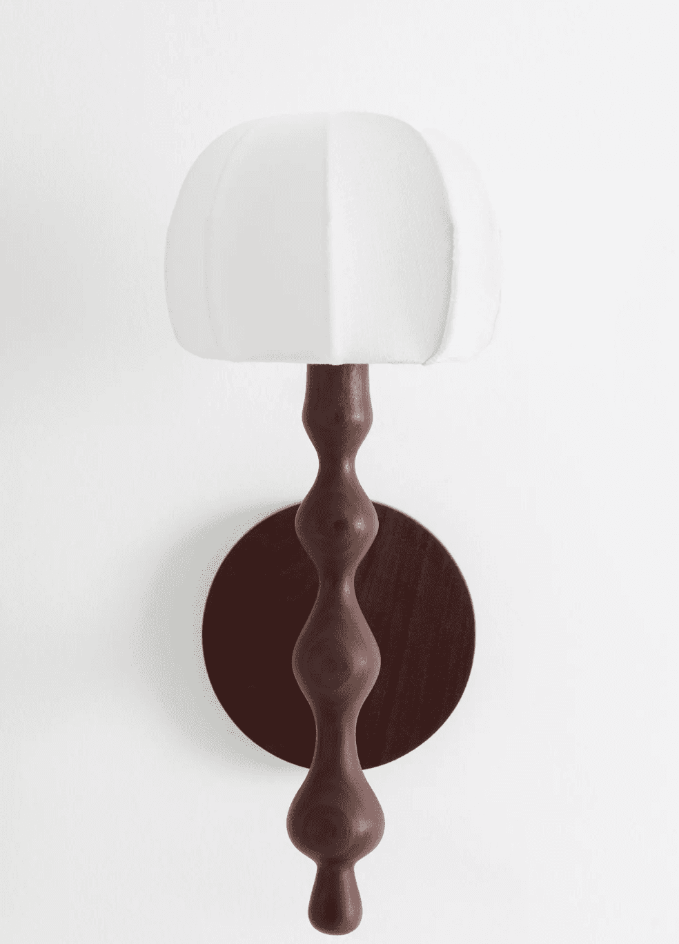 A wall-mounted lighting fixture featuring a circular dark wood backplate and a sinuously turned wood… — 3D model