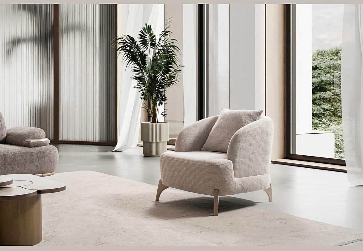 An upholstered armchair with a curved backrest and armrests, featuring a loose back cushion and supp… — free OBJ 3D model