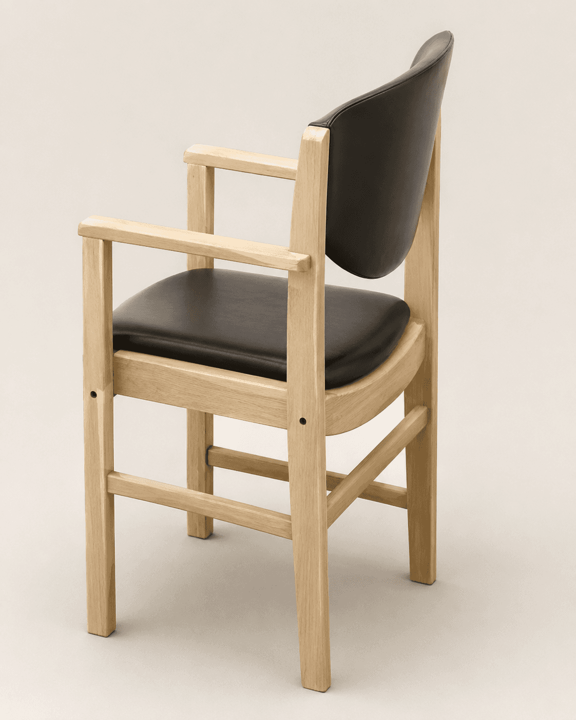 A modern armchair featuring a solid light-colored wooden frame with black padded upholstery on both… — free OBJ 3D model