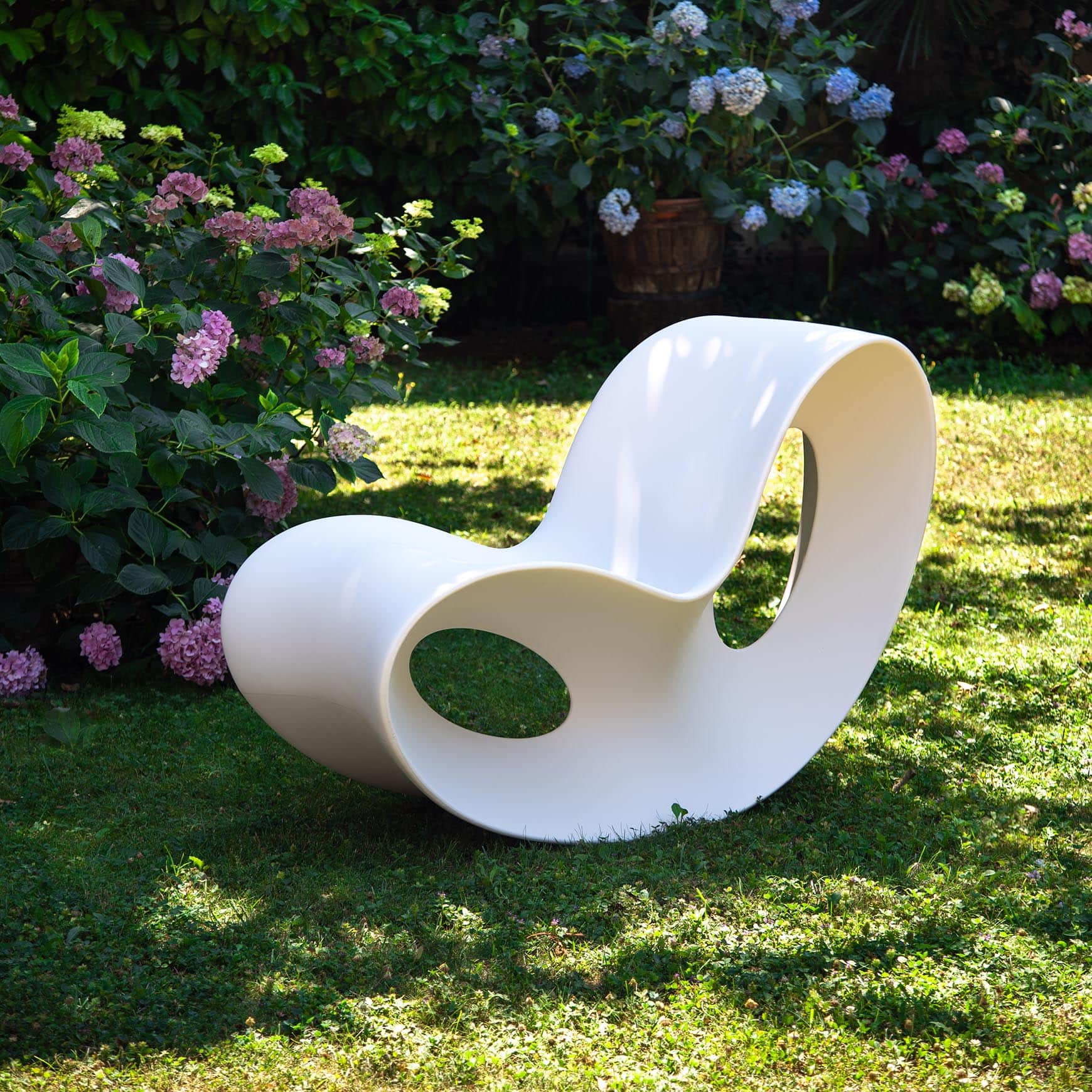 A pristine white modern sculptural rocking chair, featuring a continuous, organic form with hollowed… — 3D model