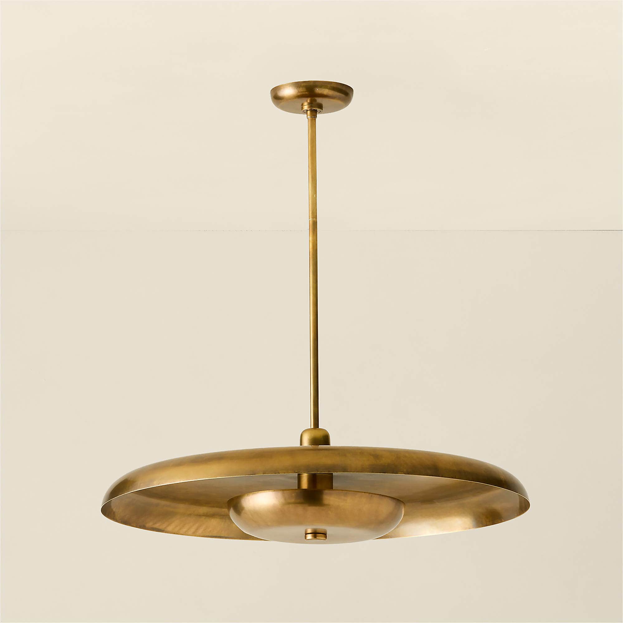 A brass chandelier featuring a tiered, disc-like shade with a central inverted dome. The fixture is… — 3D model
