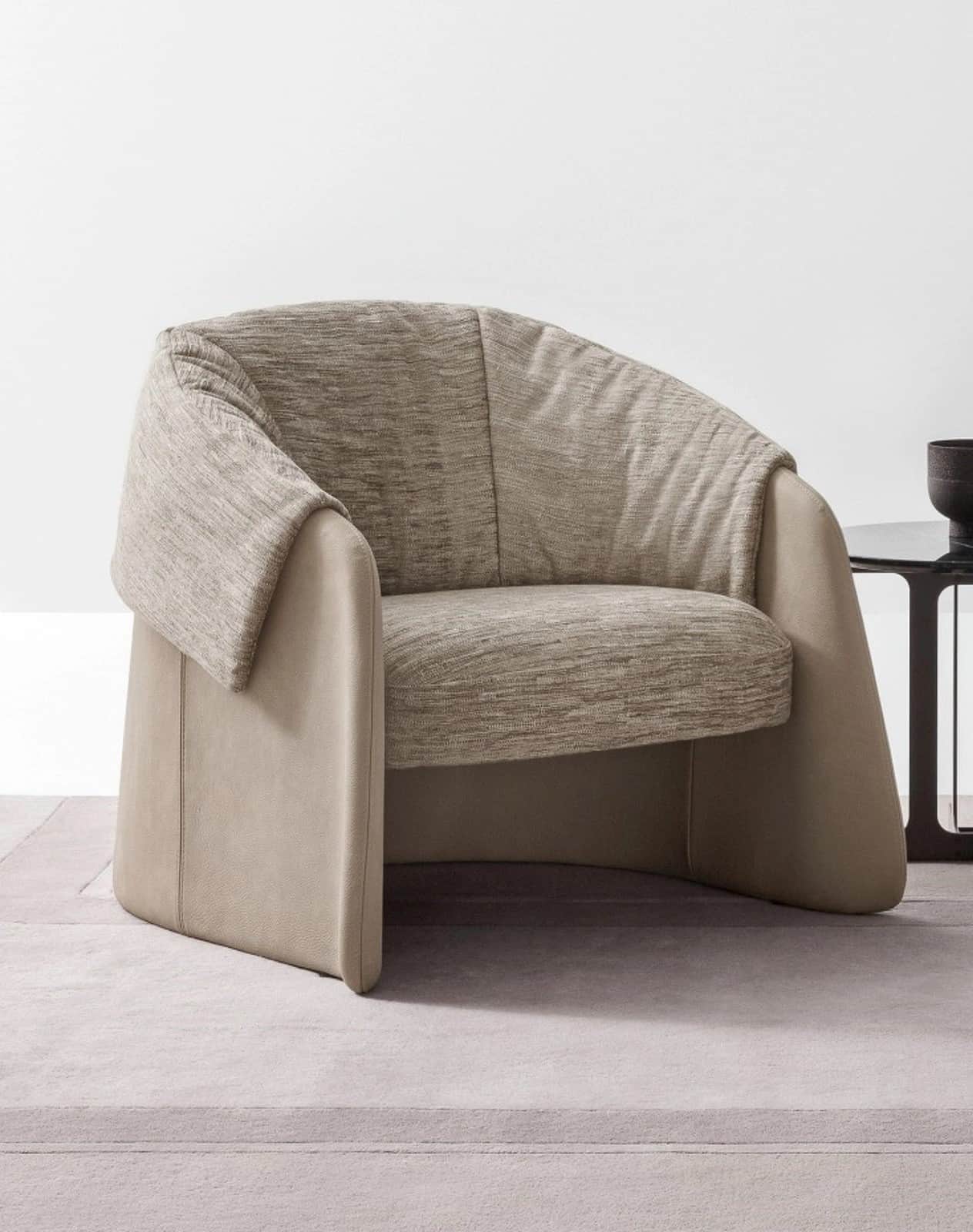 A contemporary lounge chair featuring a two-tone upholstery design, with a smooth, light beige outer… — free BLEND 3D model