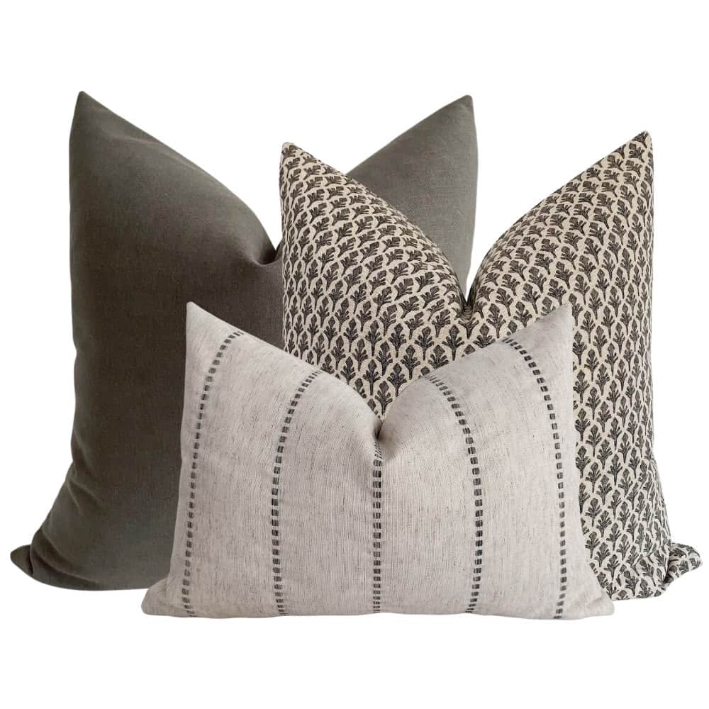 A set of three decorative throw pillows. One pillow is a solid dark grey, likely velvet or a similar… — free OBJ 3D model