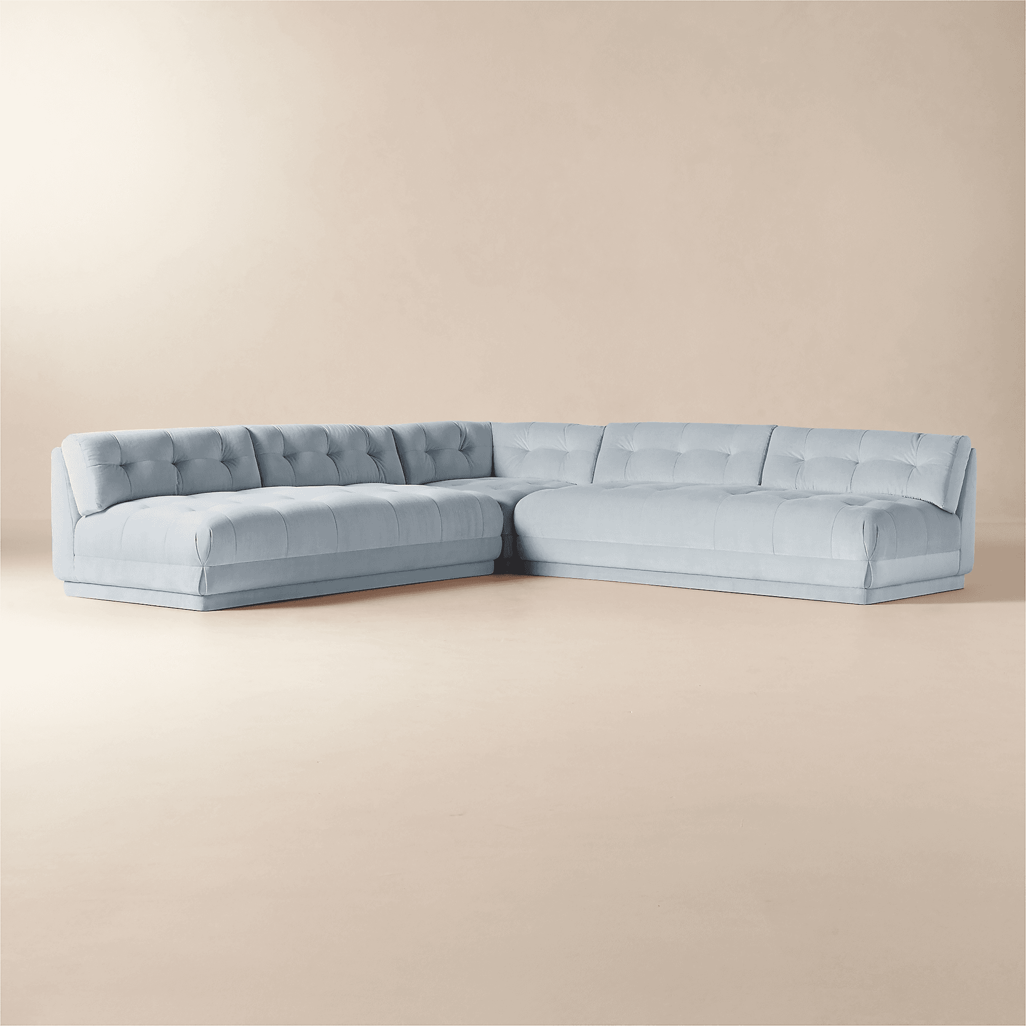 A light blue, tufted sectional sofa with a low profile and a modern design. The sofa features deep s… — 3D model