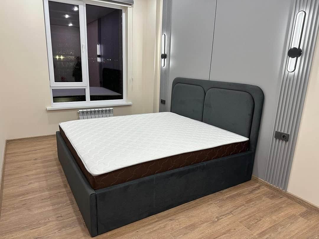 A contemporary upholstered platform bed featuring a dark gray fabric frame and a matching headboard.… — free FBX 3D model