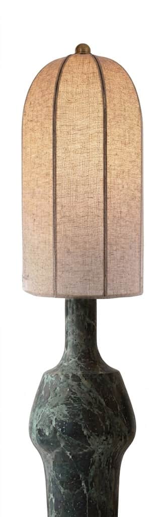 A distinctive table lamp featuring a heavily patinated, sculptural metal base in a dark green-bronze… — 3D model