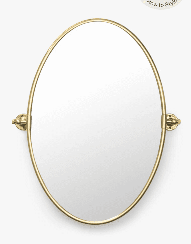 An oval-shaped mirror featuring a slender, polished brass-tone metal frame. The mirror is designed f… — 3D model
