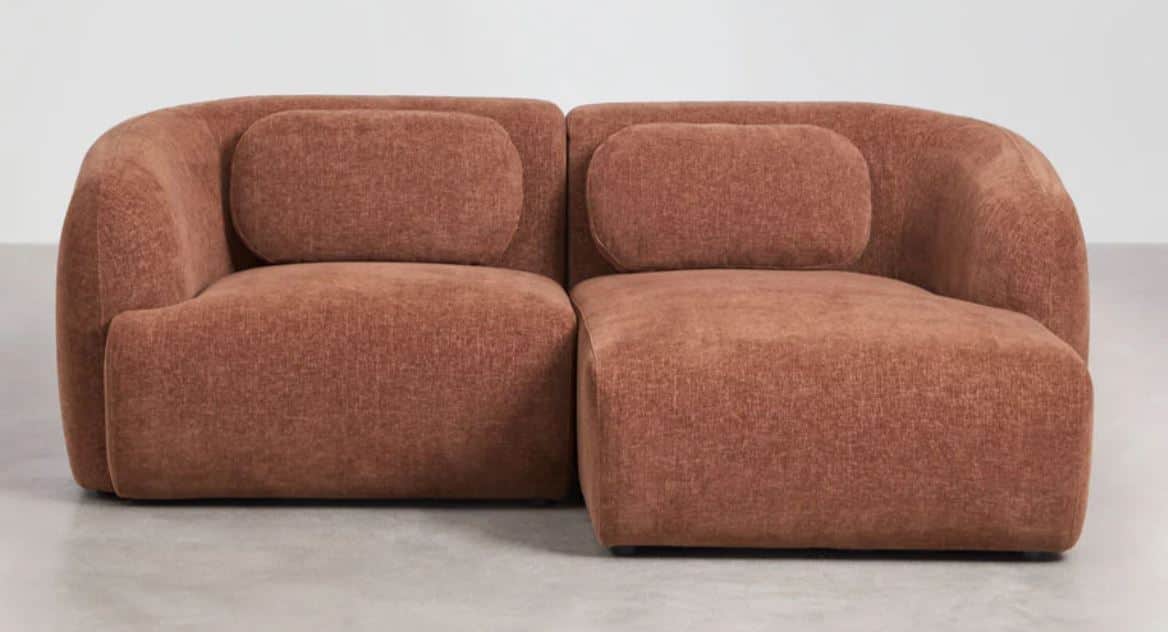 A modern, two-seater loveseat with a modular design, upholstered in a rust-colored woven fabric. It… — 3D model