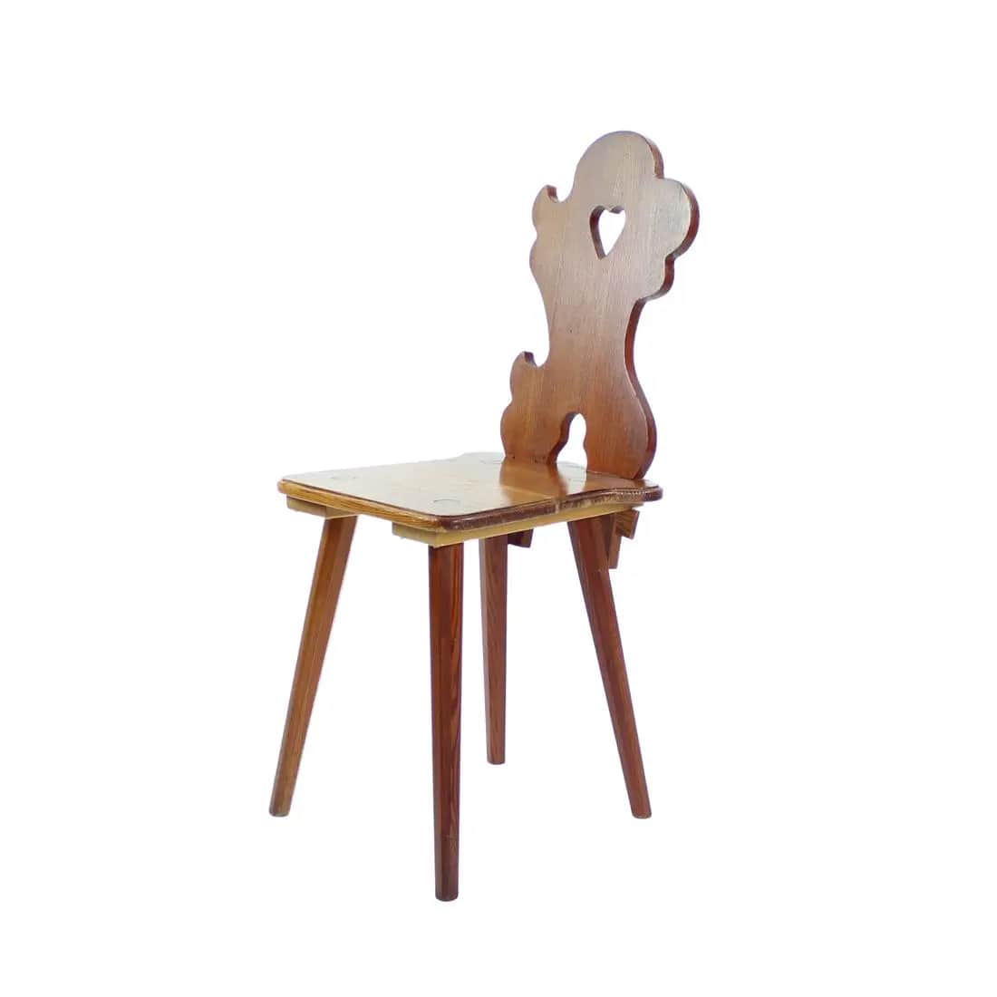 A vintage wooden chair with a uniquely shaped backrest featuring a heart cutout. The chair has a sim… — free GLTF 3D model