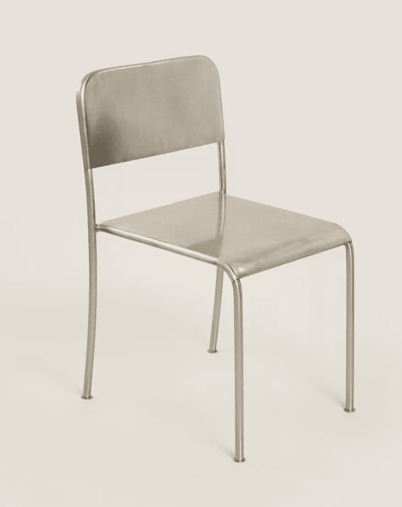 A minimalist, modern armless chair constructed entirely from metal, featuring a tubular frame, a fla… — 3D model