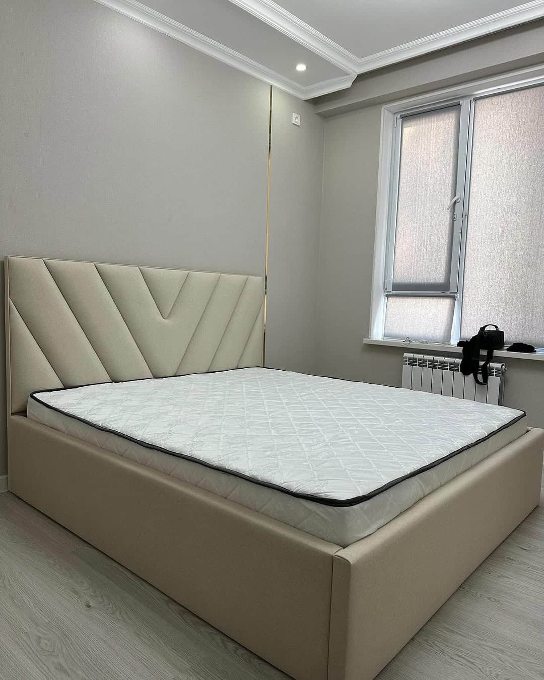 A modern platform bed featuring a light beige upholstered frame and headboard. The headboard is ador… — free FBX 3D model