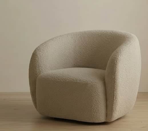 A modern armchair with a rounded, upholstered form. It features a plush, textured fabric and a low p… — 3D model