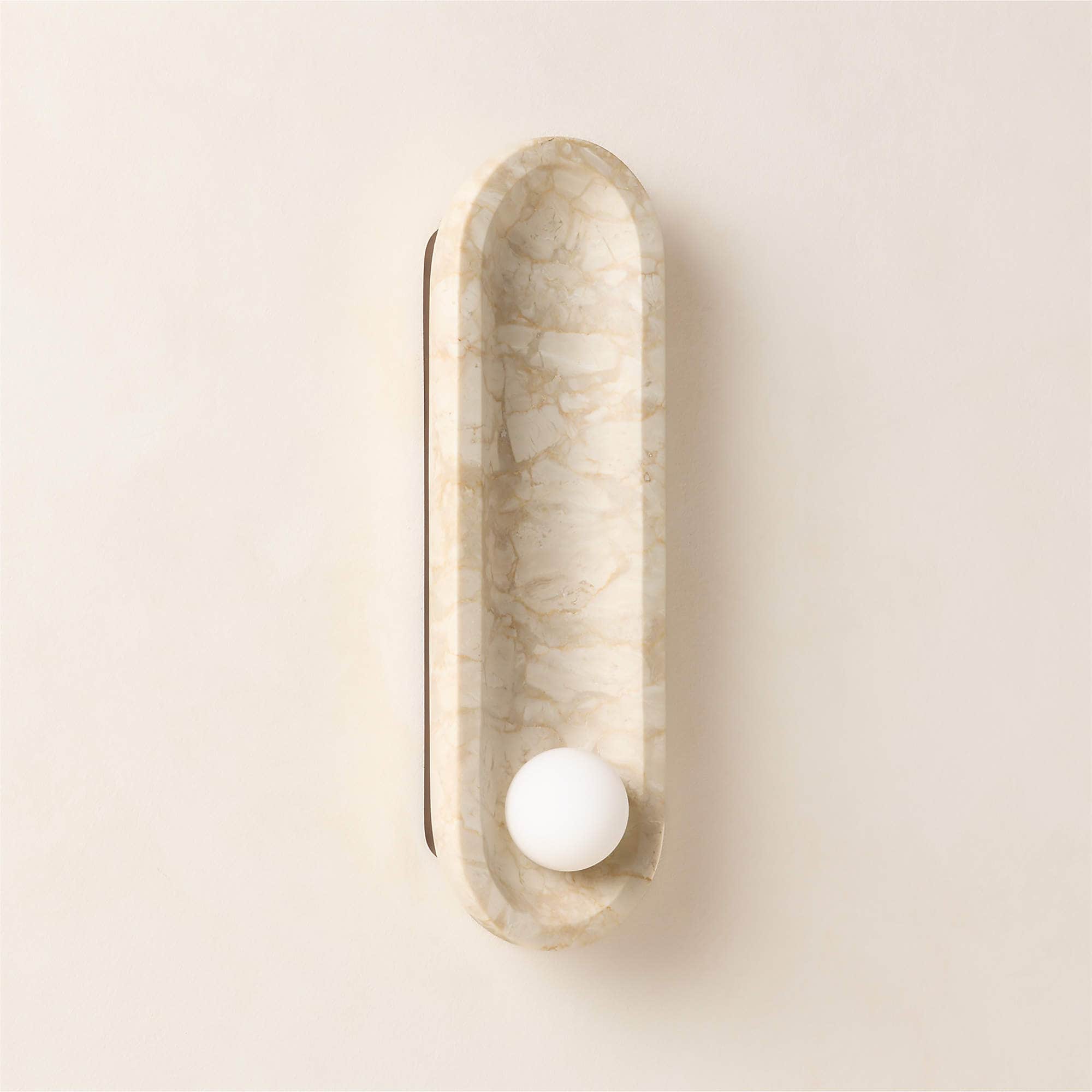 An elongated, capsule-shaped wall sconce made from light-colored marble with prominent grey veining,… — 3D model