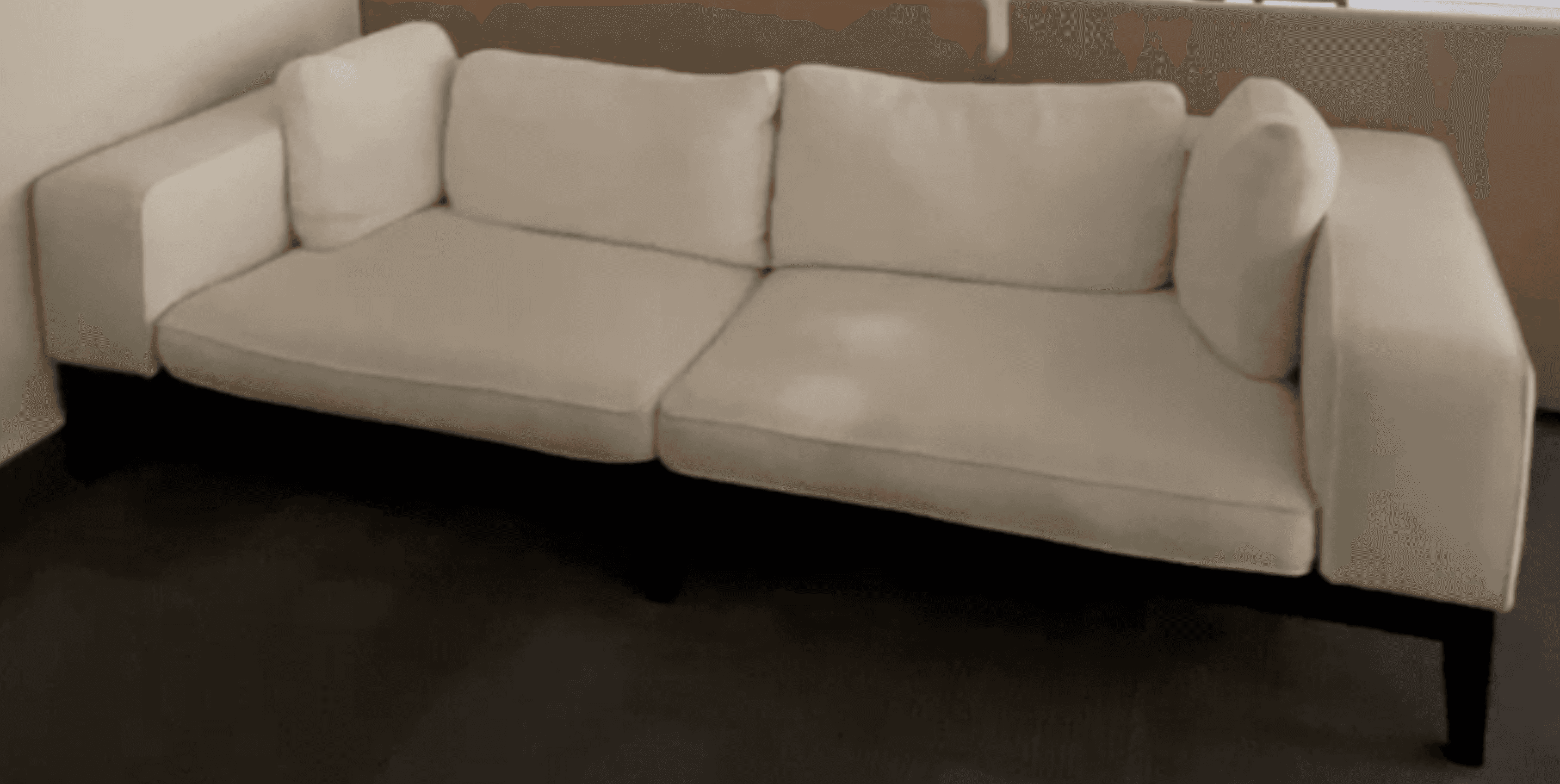 A modern, minimalist sofa featuring white textured fabric upholstery and a distinct exposed black fr… — 3D model