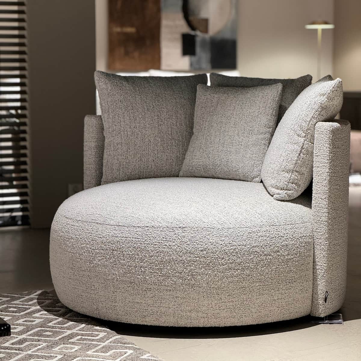 A contemporary armchair with a rounded, enveloping silhouette. It features a textured boucle fabric… — free OBJ 3D model