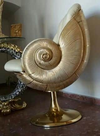 A highly decorative accent chair featuring a distinctive shell-like back and arms in a gold finish,… — free OBJ 3D model