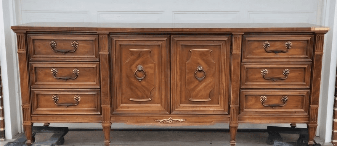 A long, wooden dresser with a traditional design. It features two cabinet doors in the center, each… — free OBJ 3D model