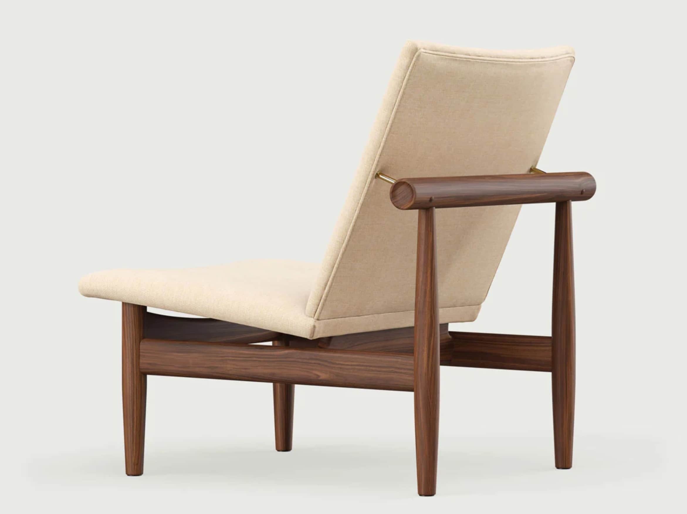 A modern armchair with a minimalist design, featuring a reclined upholstered backrest and seat, supp… — free GLTF 3D model