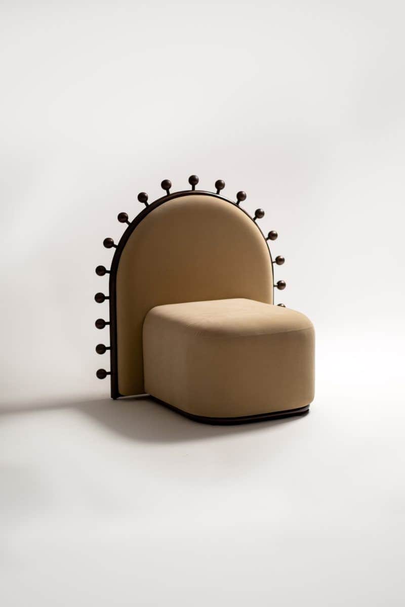 An unusual armless accent chair featuring a plush, beige upholstered seat and an tall, arched backre… — 3D model