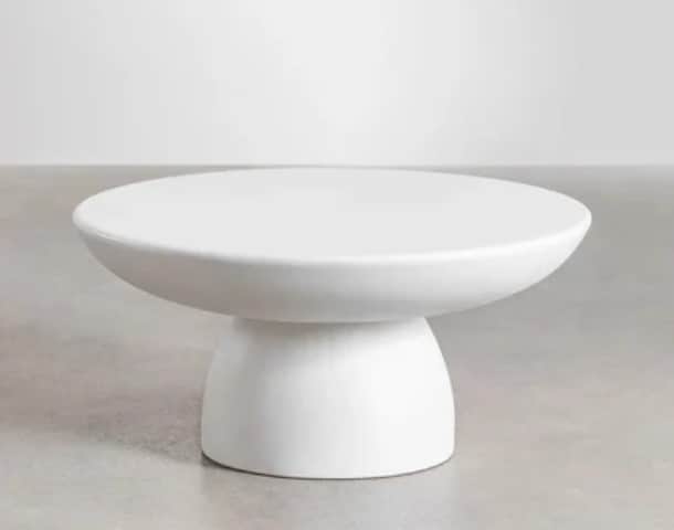 A modern round coffee table featuring a smooth, matte white finish and a substantial pedestal base,… — 3D model