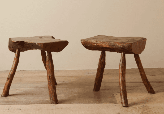 A rustic three-legged stool with an irregular, organic-shaped seat. The seat appears to be made from… — 3D model
