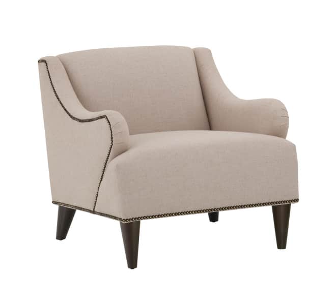 A beige upholstered armchair with dark wooden legs. The armchair features a high back that curves in… — free OBJ 3D model