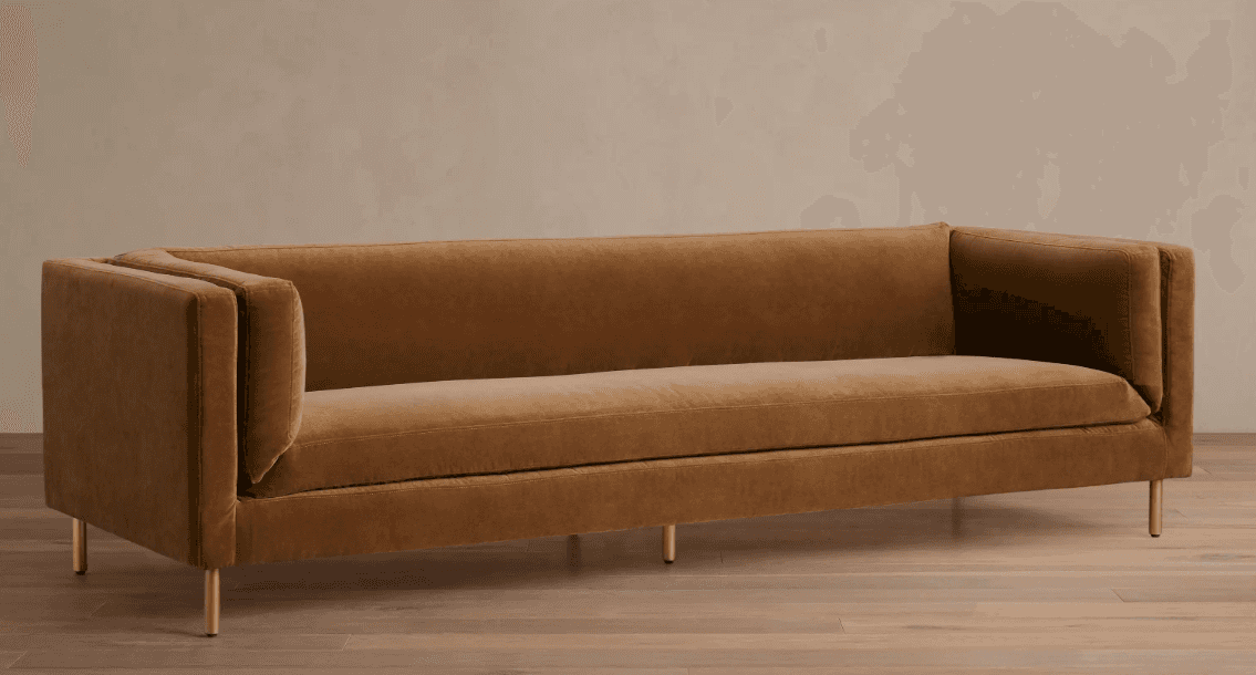 A modern, three-seater sofa with track arms and thin metal legs, upholstered in a brown velvet-like… — 3D model
