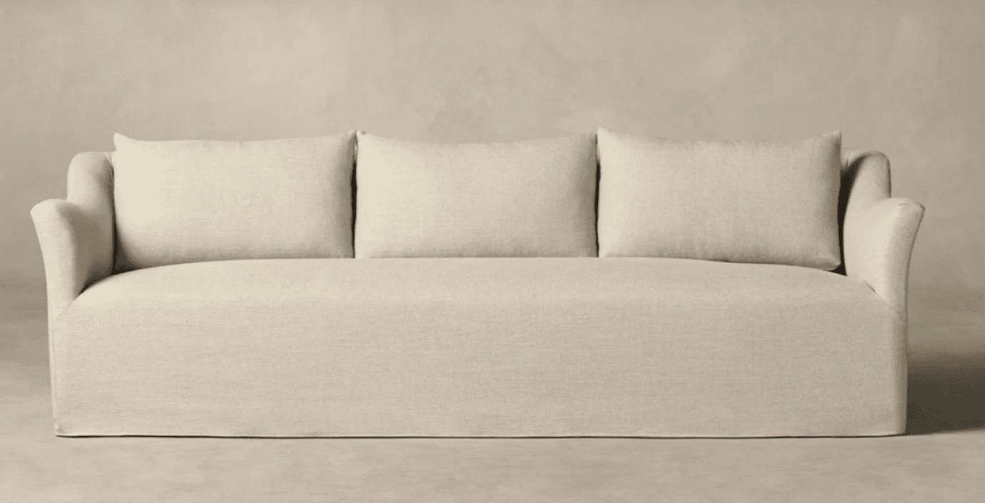A three-seater sofa with a skirted base and three rectangular back cushions. The sofa features gentl… — 3D model