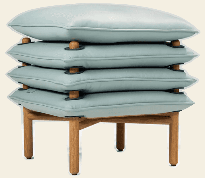 A modern ottoman featuring a stacked cushion design atop a wooden base. The cushions appear to be up… — free FBX 3D model