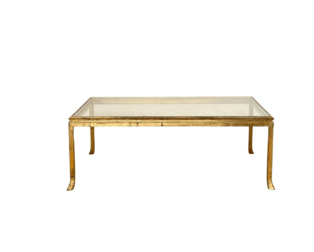 A rectangular coffee table with a clear glass top and a gold-toned metal frame. The frame has a dist… — free FBX 3D model
