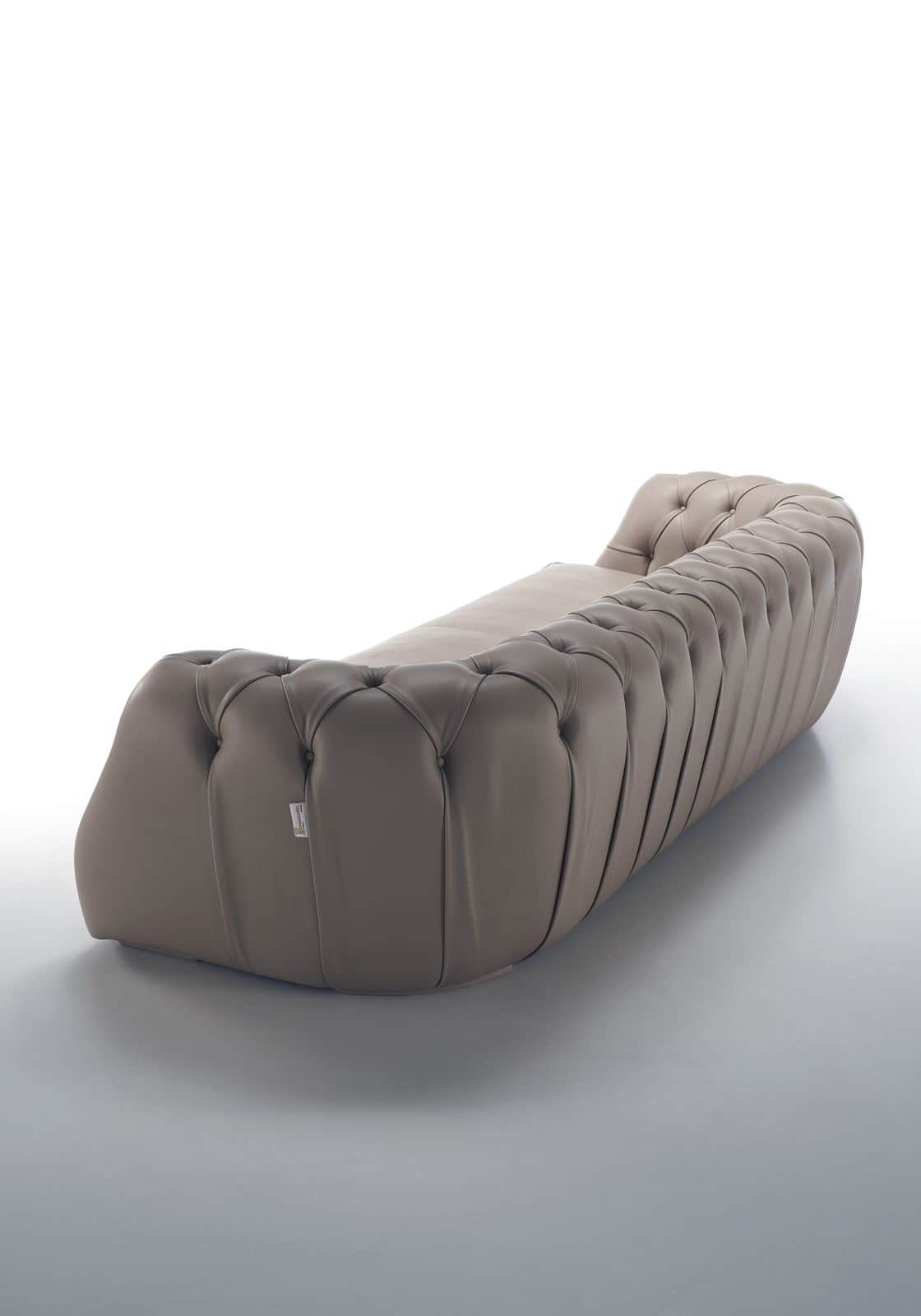 A contemporary chaise lounge featuring deep button tufting on its curved ends and pleated detailing… — 3D model