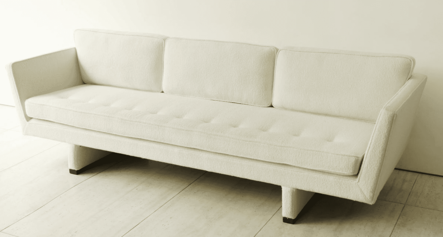 A contemporary three-seater sofa upholstered in an off-white bouclé-like fabric, featuring a single… — free SKP 3D model