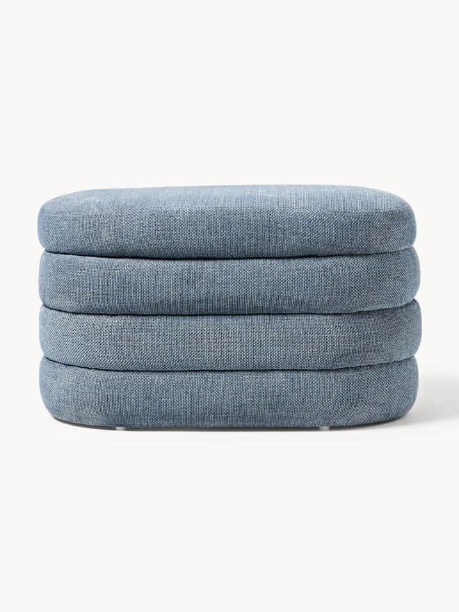 A stack of four upholstered ottomans, each with a rounded rectangular shape and a textile covering.… — 3D model