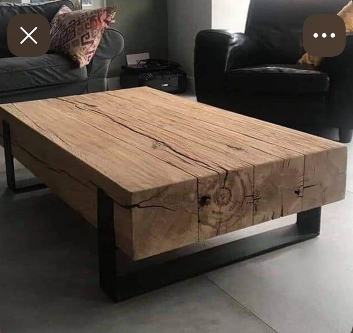 A rustic industrial coffee table featuring a thick, rectangular slab of natural wood as its top, sup… — 3D model