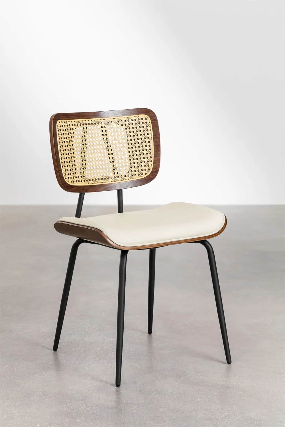 A contemporary dining chair featuring a curved dark wood frame with a woven cane backrest, an uphols… — 3D model