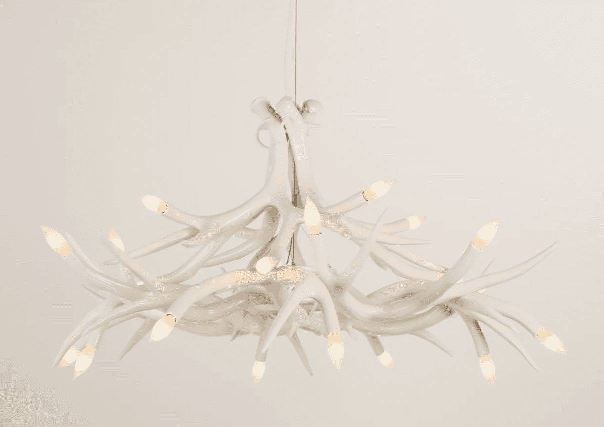 A white chandelier designed to resemble a cluster of antlers. It features multiple branching element… — 3D model