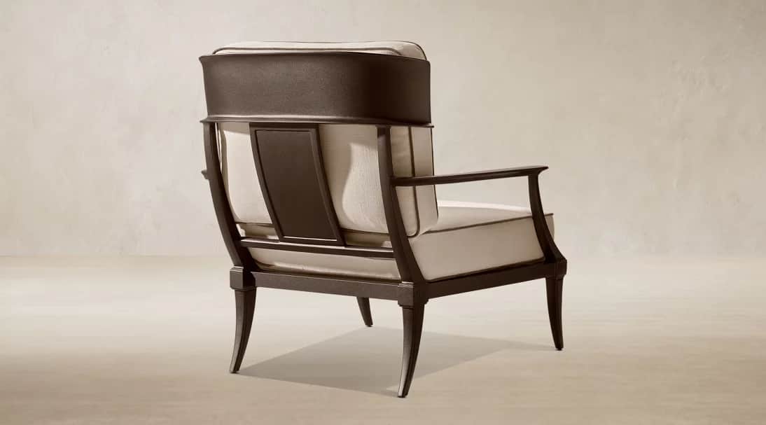 A contemporary lounge armchair featuring a dark-toned exposed metal frame and plush, light-colored u… — 3D model