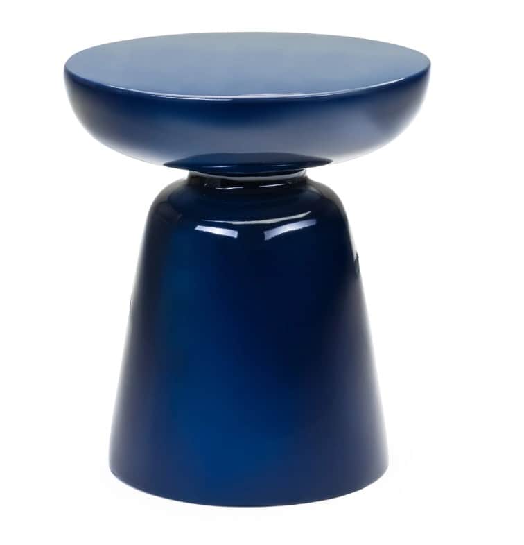 A dark blue, glossy side table with a pedestal base. The tabletop is round and slightly concave, tra… — 3D model