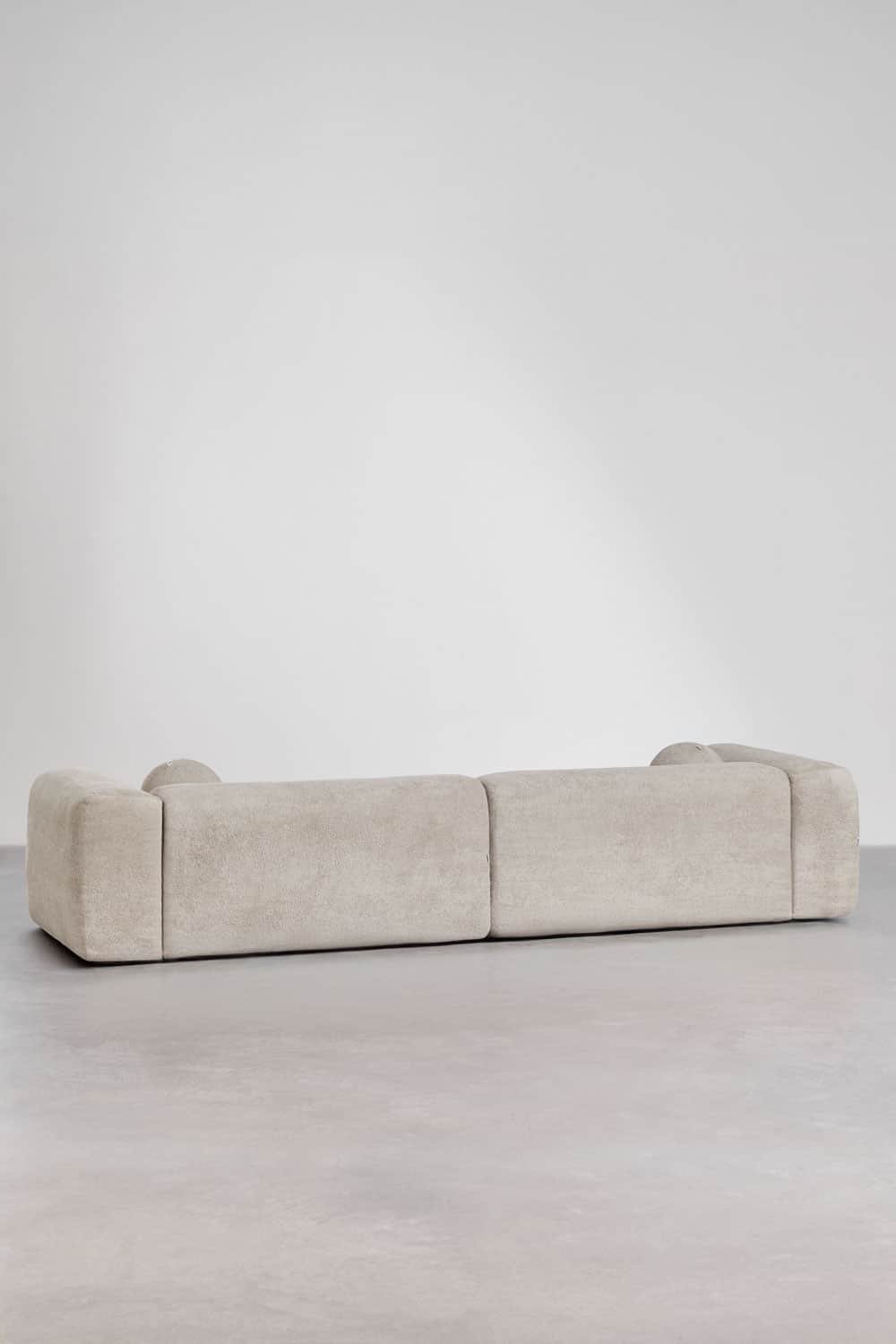 A contemporary, low-profile modular sofa upholstered in a light cream textured fabric, featuring sof… — 3D model