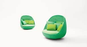 A vibrant green outdoor pod daybed featuring a durable woven synthetic rattan frame, shaped into a s… — 3D model