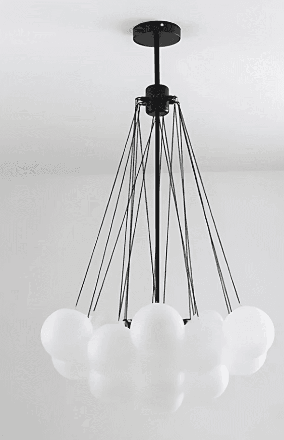 A modern chandelier featuring a black metal frame with multiple thin suspension wires supporting a c… — 3D model