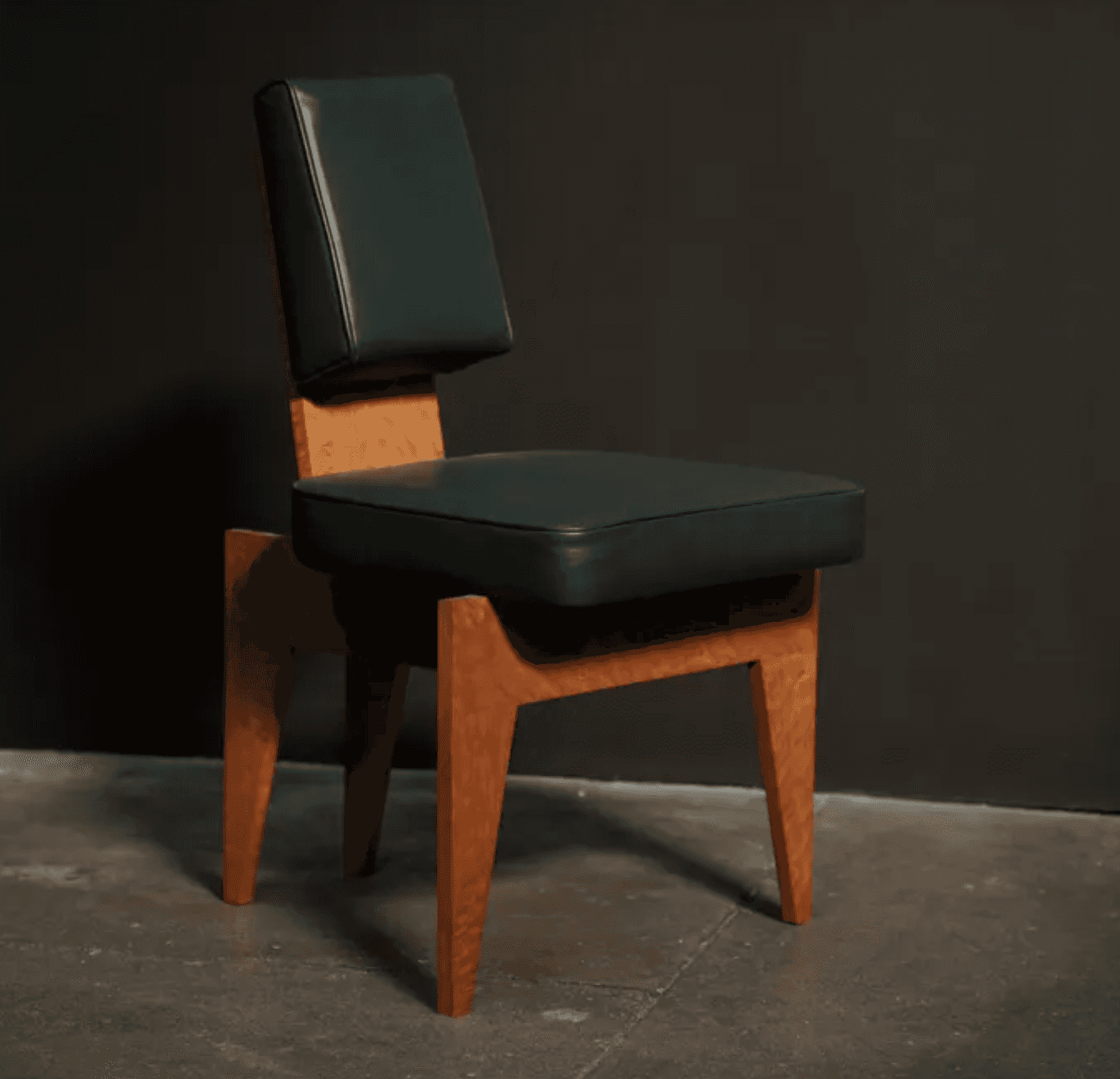 An armless chair featuring a distinctive geometric wooden frame with a light-colored, possibly burle… — 3D model