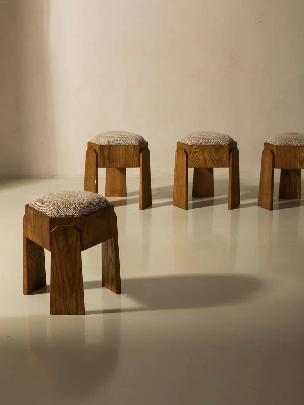 A wooden stool with an upholstered hexagonal seat. The stool has four legs, with two facing front an… — 3D model