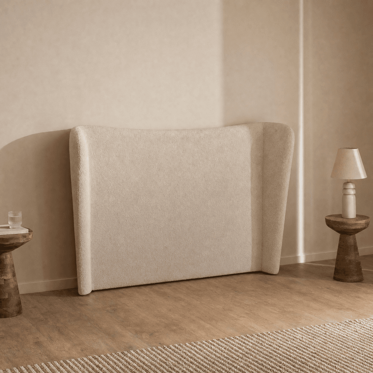 A modern upholstered headboard featuring a wingback design, covered in a textured, light beige fabri… — 3D model
